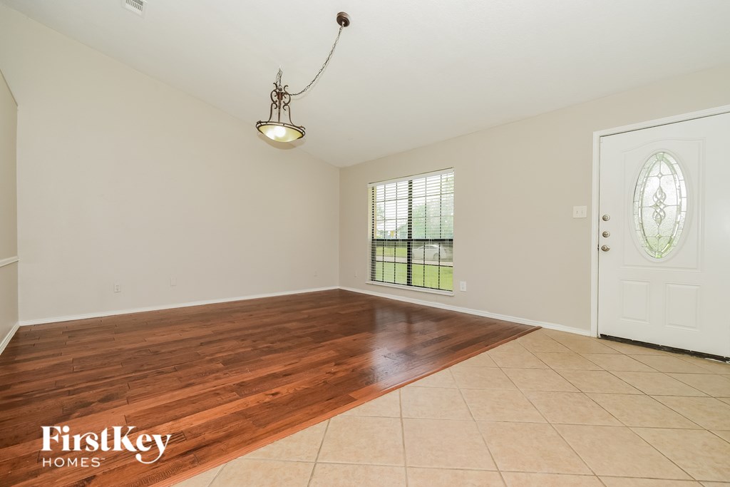 A room with wooden flooring and a white door.