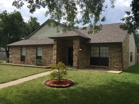 a house with a tree in the front yard