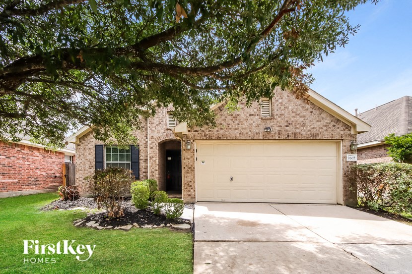 a garage door in front of a brick house