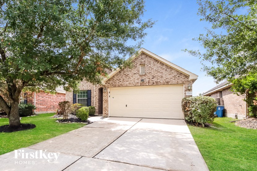 a garage door in front of a brick house