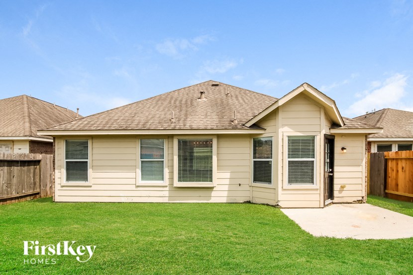 a house with a yard and a wooden fence