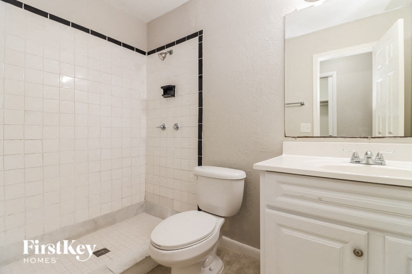 a white bathroom with a toilet and a sink