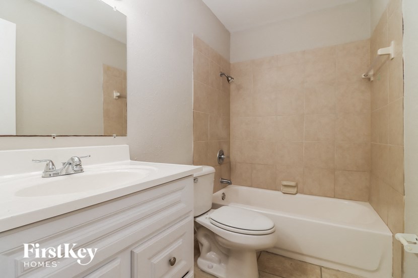 a bathroom with a sink toilet and a bath tub
