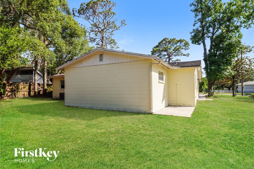 a small yellow and in a grassy yard