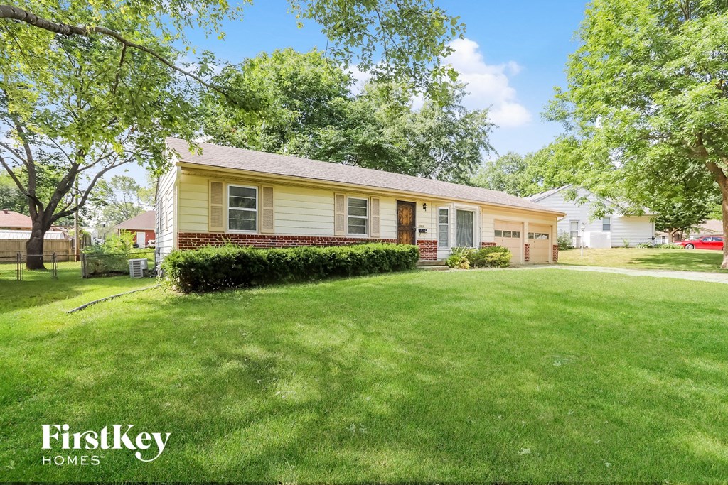 A house with a lawn in front of it.