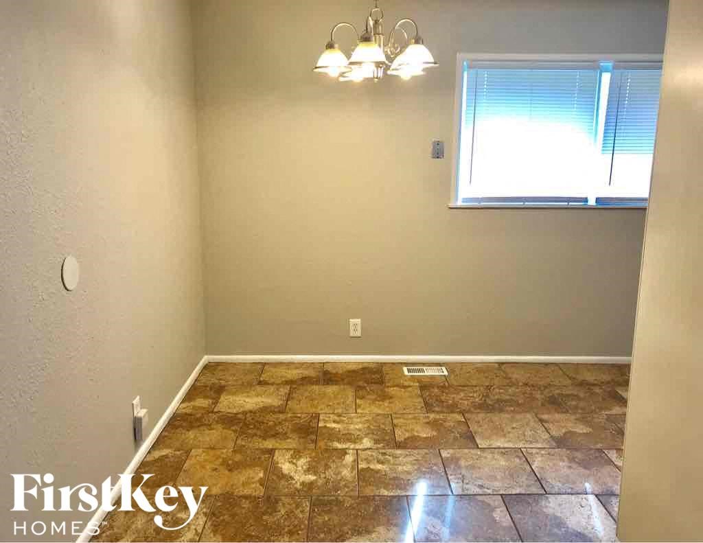 A room with a stone floor and a window.
