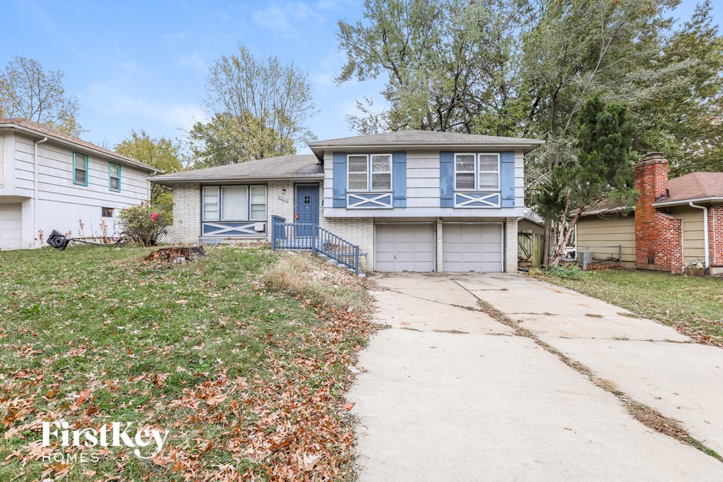 a blue and white house with a sidewalk in front of it
