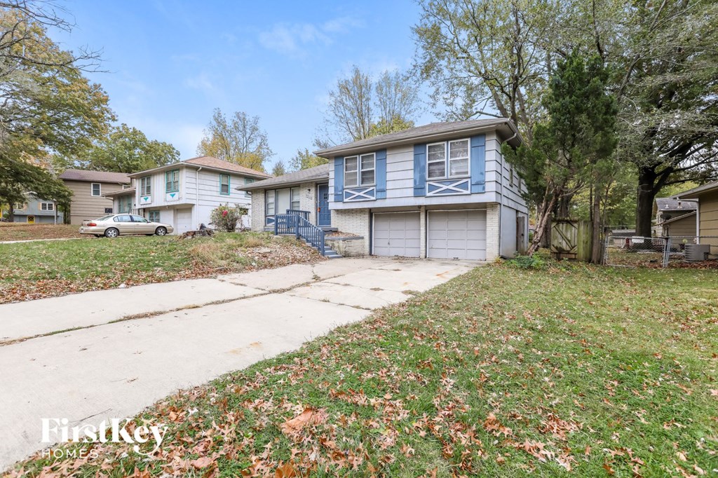 a blue and white house with a sidewalk in front of it