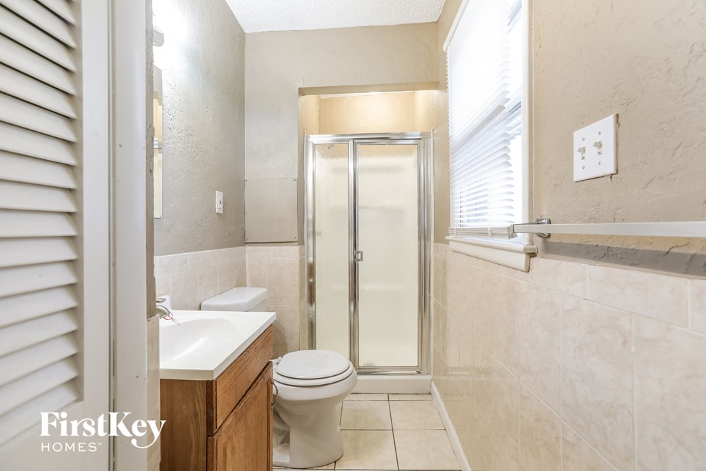 a small bathroom with a shower toilet and sink