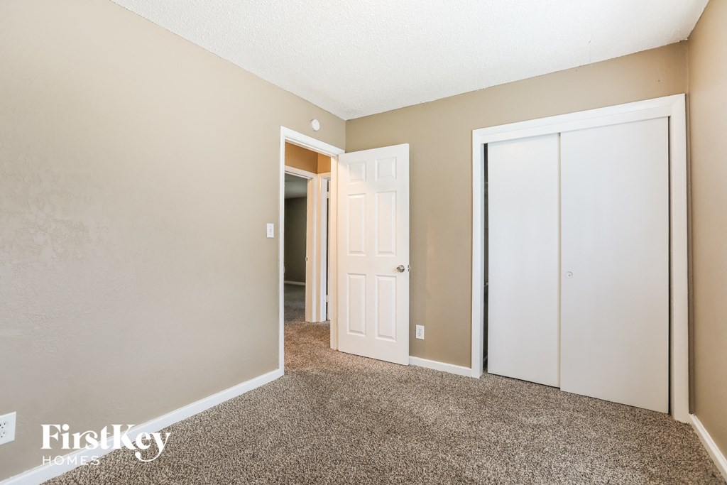 a bedroom with two closets and a door to a hallway