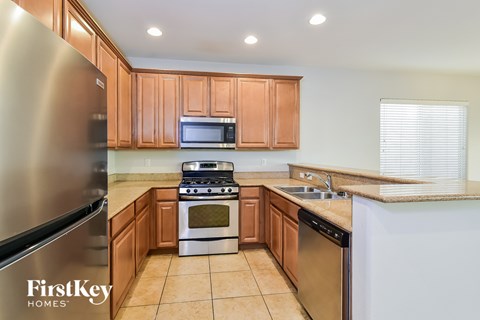 A kitchen with wooden cabinets and stainless steel appliances.