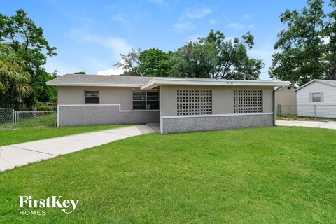 A house with a well-maintained lawn in front of it.