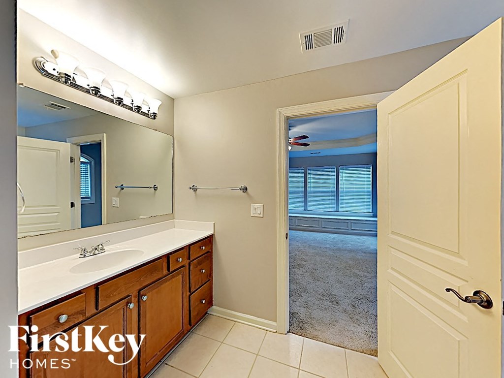 a bathroom with a large mirror and a sink