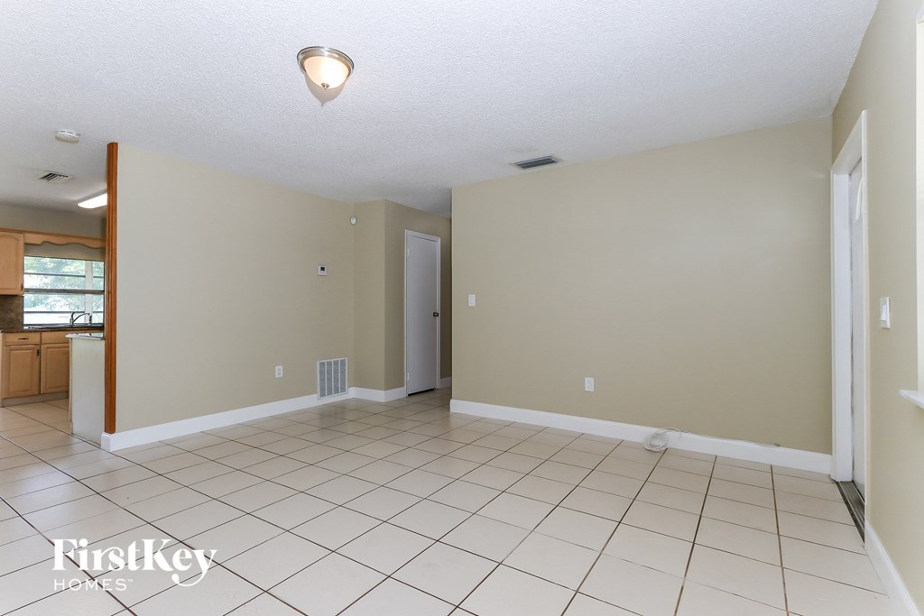 A spacious room with a tiled floor and a ceiling light.