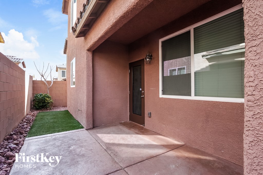 A house with a brown stucco exterior and a black door.