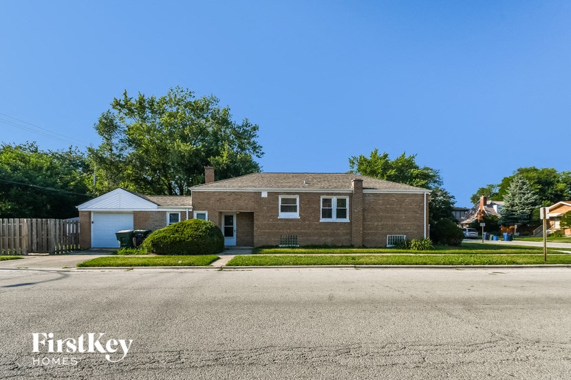 a brick house on the corner of a street
