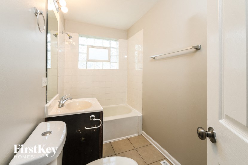 a bathroom with a sink toilet and a bath tub