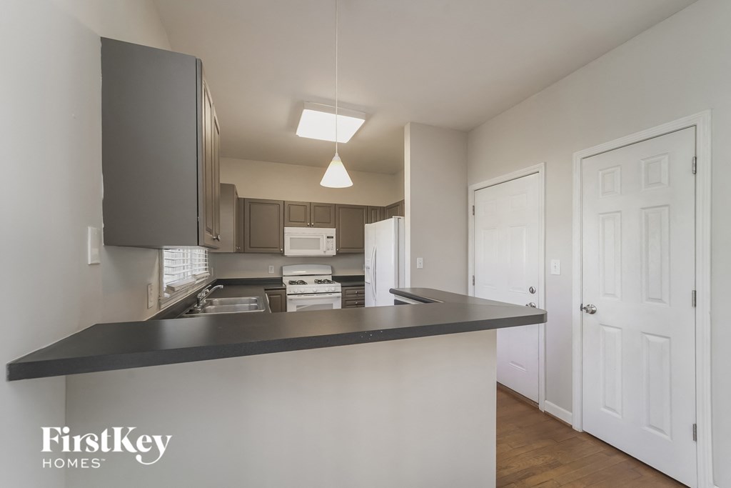 a kitchen with a black counter top in a house