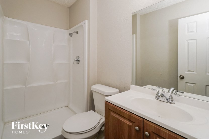 a bathroom with a sink toilet and a shower