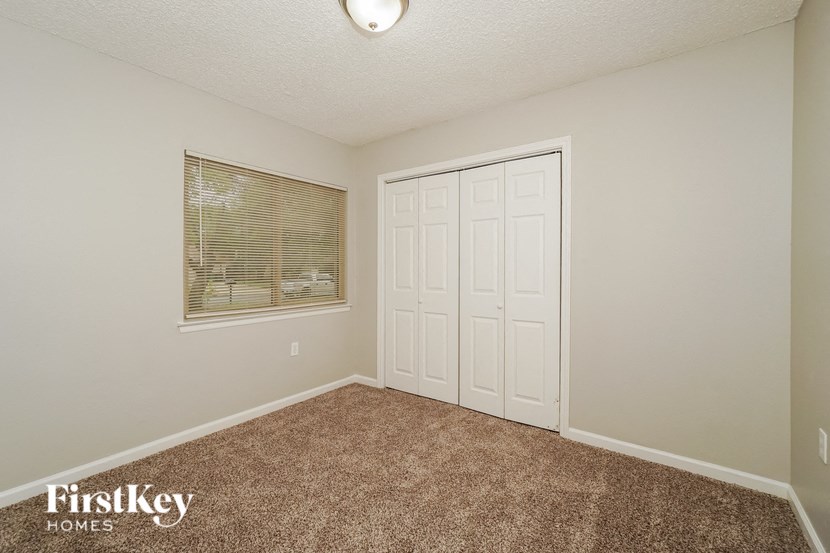 an empty room with a door and a window