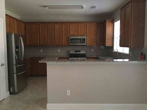 a kitchen with a counter top and a refrigerator