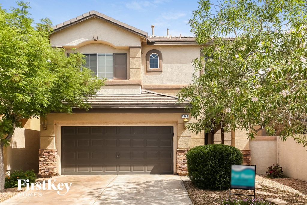A house with a garage door and a sign that says "FirstKey Homes".