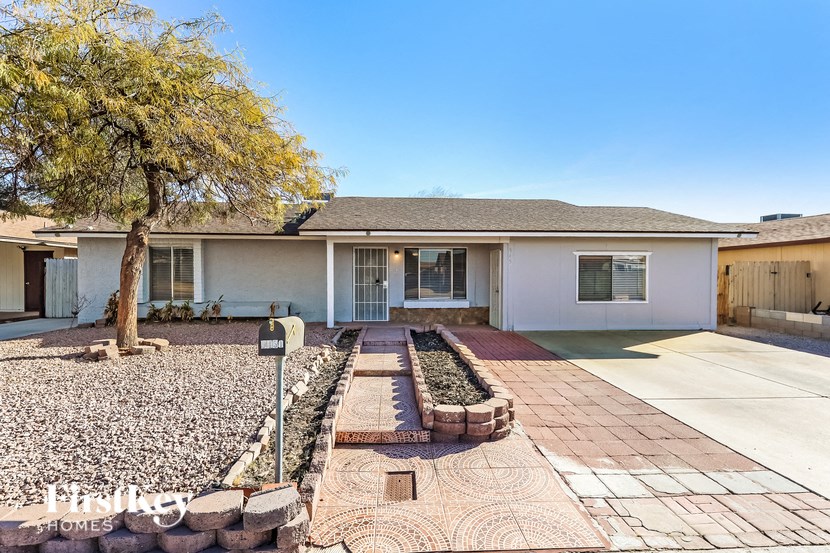 A house with a tree in front of it.