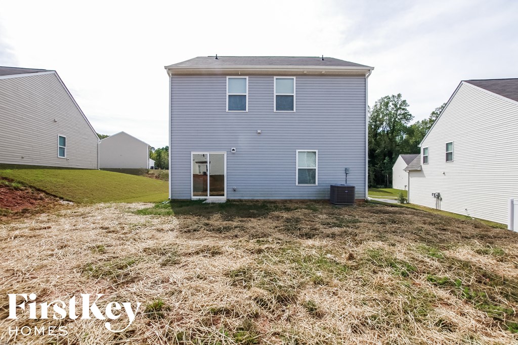 A house with a blue exterior is for sale by Firstkey Homes.