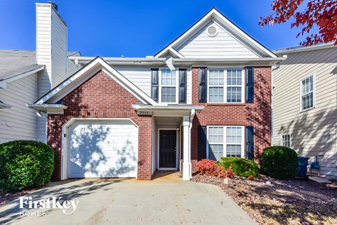 a large brick house with a white garage door