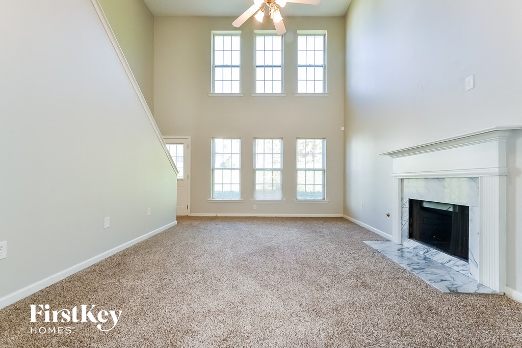 a living room with a fireplace and a carpeted floor