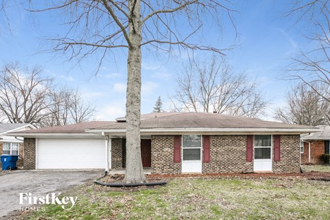 a brick house with a tree in front of it