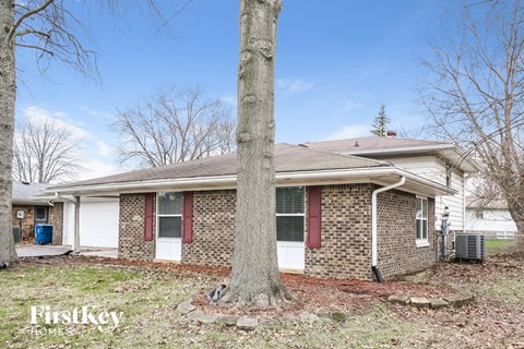 a brick house with a tree in front of it