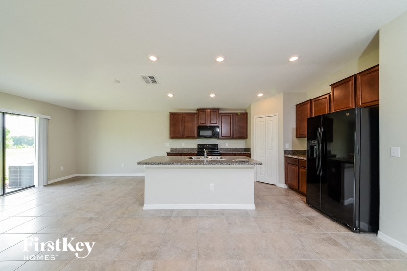 a large kitchen with black appliances and a large island