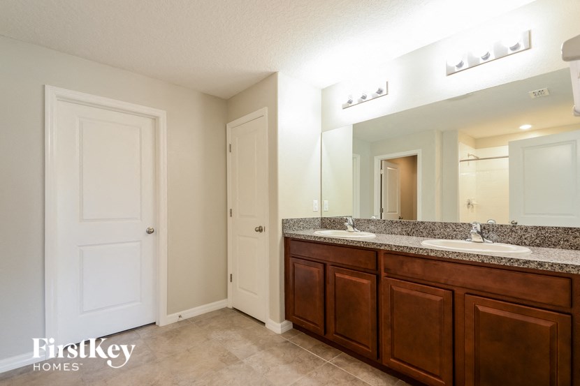 a bathroom with two sinks and a large mirror