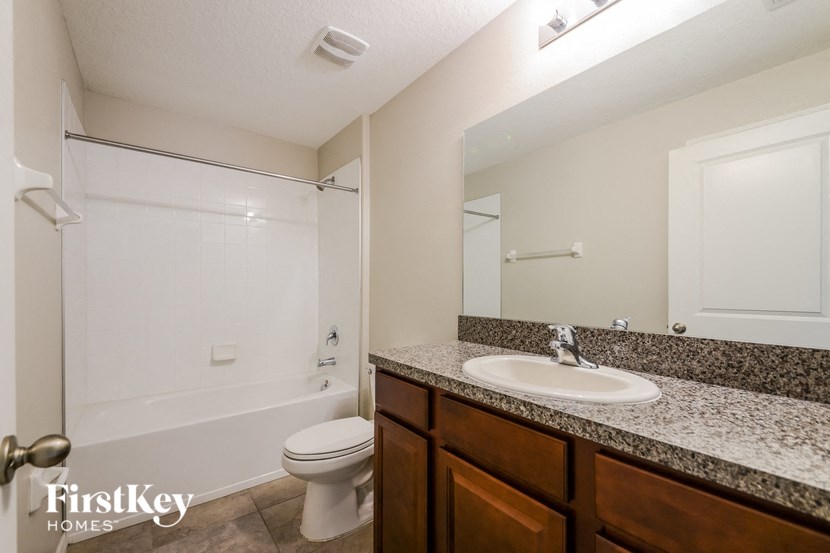 the interior of a bathroom with a sink toilet and shower