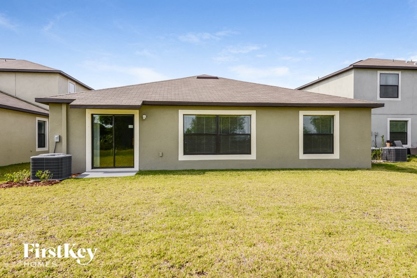 a home with a grass yard and a patio