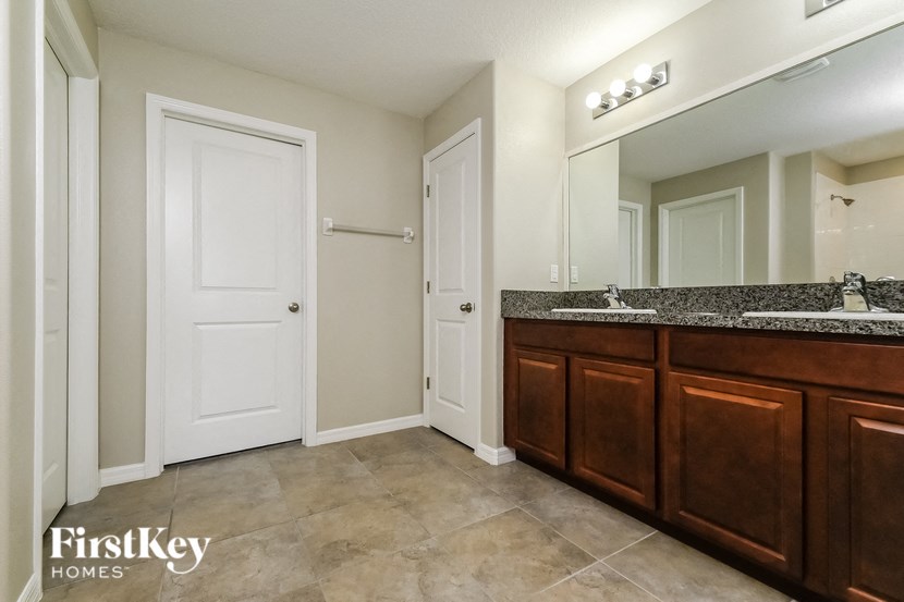 a bathroom with two sinks and a large mirror