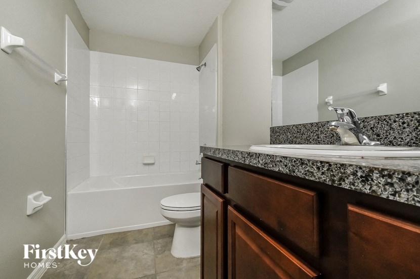 a bathroom with a toilet and a sink and a bath tub