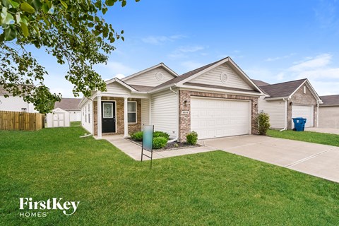 A house with a garage and a driveway is shown in the image.