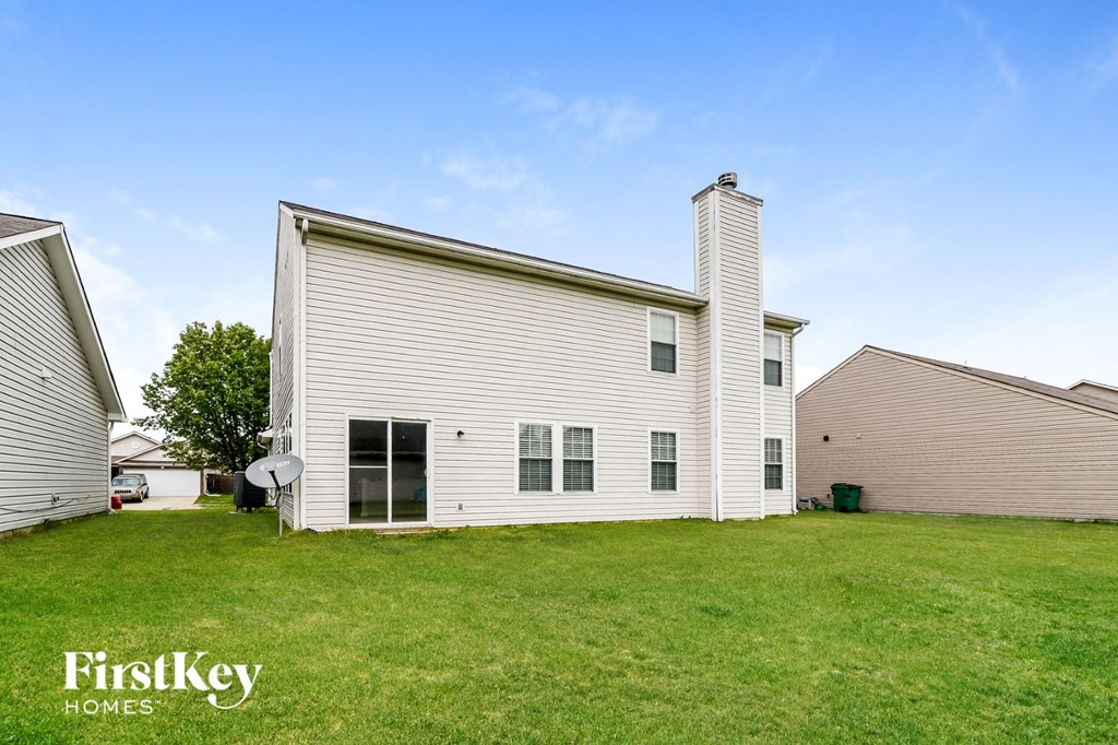 a white house with a yard in front of it