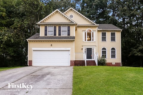 A two-story house with a garage is for sale.