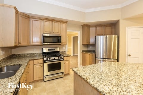 A kitchen with granite countertops and stainless steel appliances.