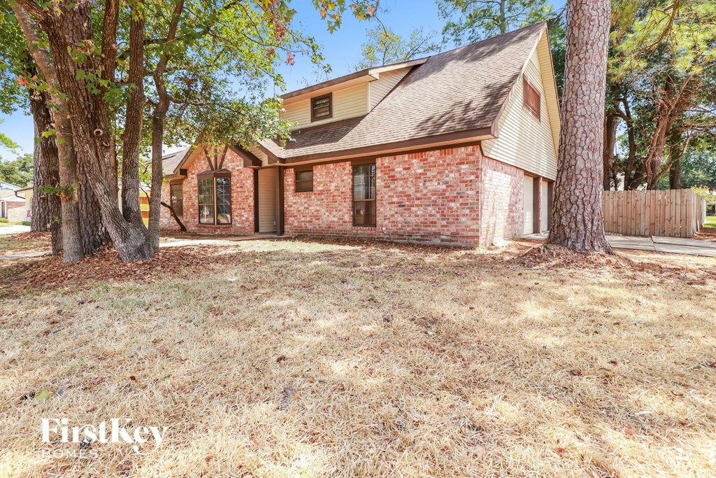 a brick house with a yard and trees