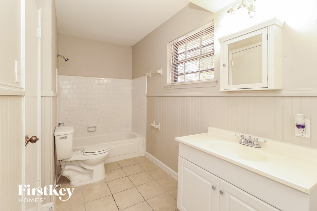 a bathroom with a toilet and a sink and a bath tub