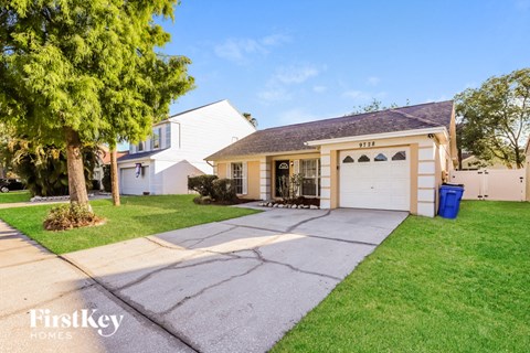 a white house with a garage and a driveway