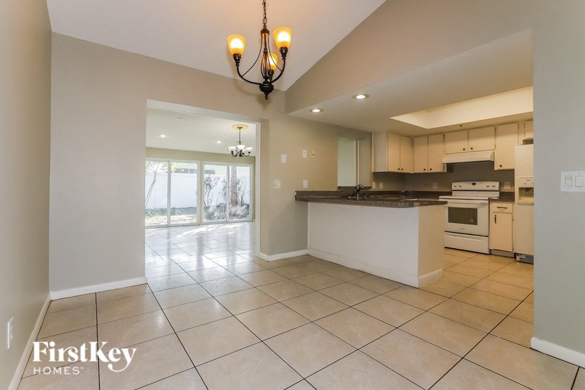 an open kitchen and living room with a view of the beach
