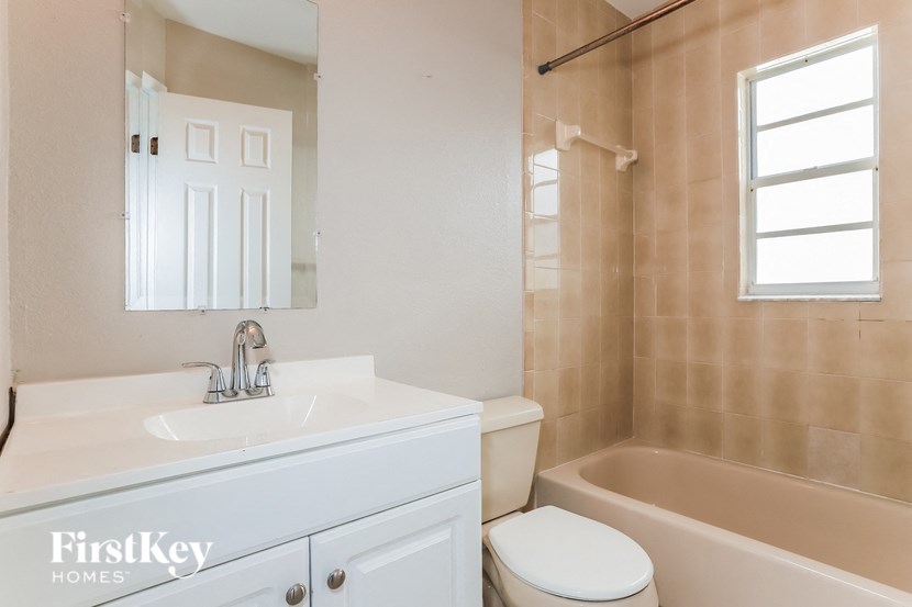 a bathroom with a sink toilet and a tub