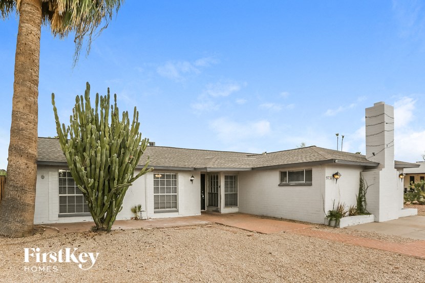 a white house with a cactus in front of it