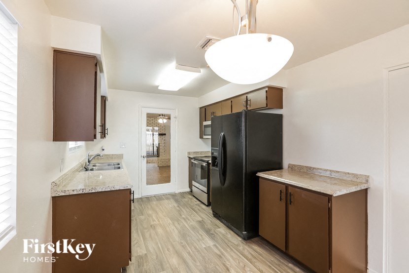 a kitchen with stainless steel appliances and wooden cabinets