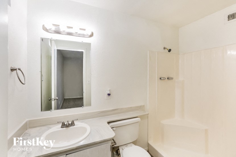 a bathroom with a sink toilet and a mirror